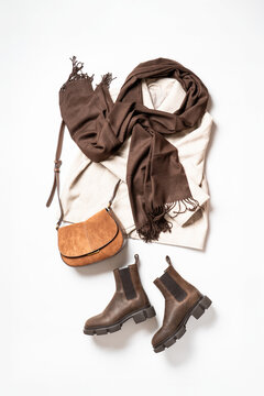 Autumn cloth and accessories at white background with copy space.