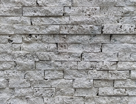 Coral stone wall texture background with porous stone blocks in modern architecture