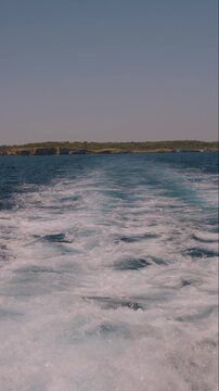 Vertical boat wake trail on open Mediterranean water