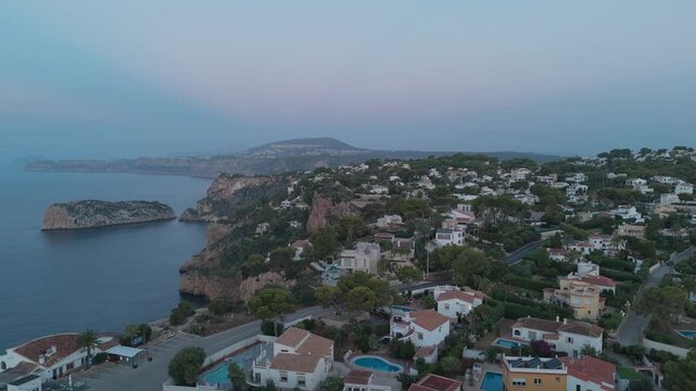 Drone flying over javea coast and cape la nao at dusk