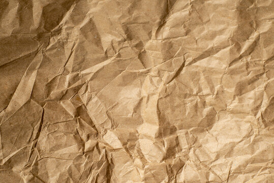 Crushed brown paper texture background with natural wrinkles and vintage recycled material appearance