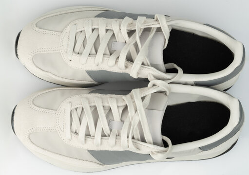 New gray and white running shoes on a white background