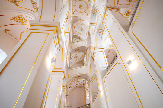 Elegant White and Gold Architectural Detail with Vaulted Ceilings and Arches