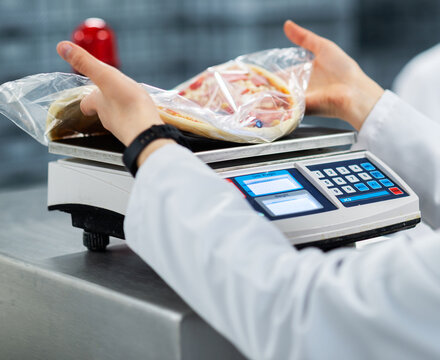 Weighing Packaged Frozen Pizza on Digital Scale