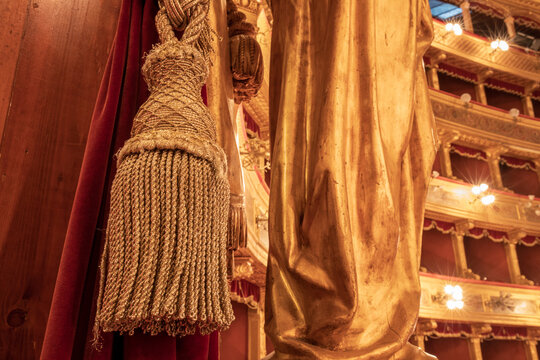 Detailed Close Up of Golden Tassel and Red Velvet Curtain in Opera House