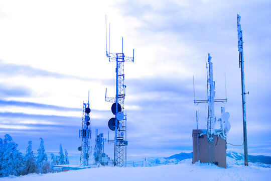 Radio and Satellite Communication Equipment Frozen with snow and Ice in the Winter Dependibility of Communications and Services