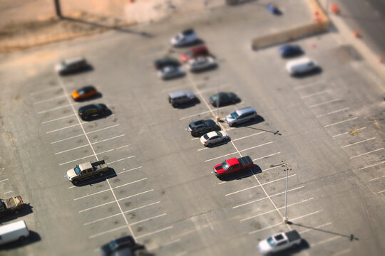 Miniature Effect on Cars in Parking Lot and on Road in Busy City