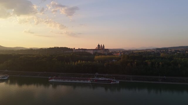 Melk Abbey in Austria, with a beautiful sunrise illuminating the historic Baroque abbey church and its magnificent architecture.