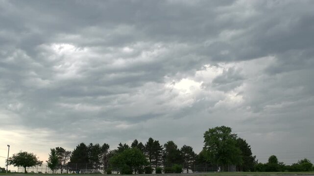 Storm clouds time lapse over trees

