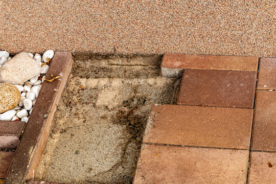 Paving stones removed for patio roof foundation work