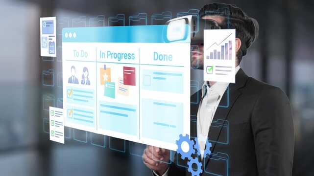 Businessman Using Virtual Reality Technology for Project Management and Task Tracking in Modern Office Environment with Digital Interface. Entropy.