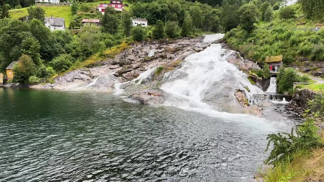 Waterfall Hellesyltfossen in Hellesylt village at overcast day, Norway