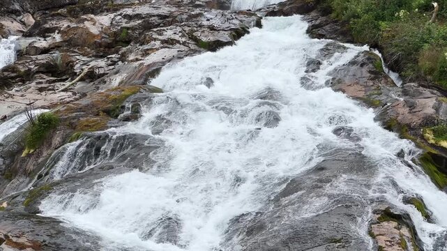 Waterfall Hellesyltfossen in Hellesylt village at overcast day, Norway