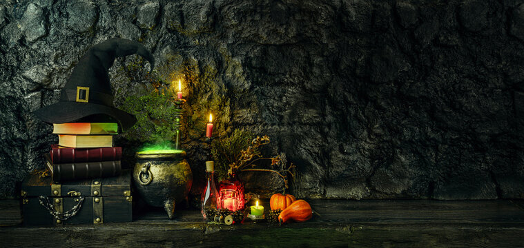 Halloween background. Dark witch cauldron with a magic witch's potion, books, chest, conical hat. Witchcraft paraphernalia and accessories among candles on a table in a room or cave with stone walls.