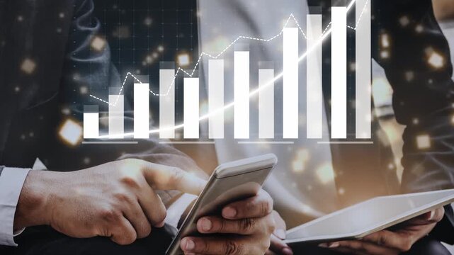 Two business professionals engage with mobile devices while analyzing a financial growth chart. The image reflects progress, teamwork, and data-driven decision-making in the corporate world. Copula