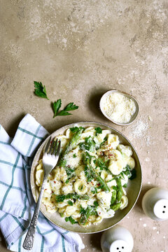 Pasta orecchiete with asparagus in a cream sause. Top view with copy space.
