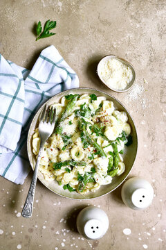 Pasta orecchiete with asparagus in a cream sause. Top view with copy space.