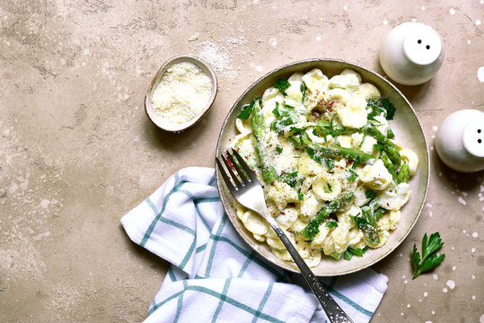 Pasta orecchiete with asparagus in a cream sause. Top view with copy space.