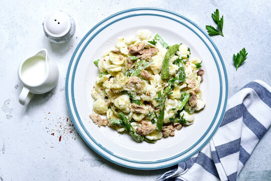 Pasta orecchiete with tuna and asparagus in a cream sause. Top view with copy space.