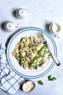Pasta orecchiete with tuna and asparagus in a cream sause. Top view with copy space.