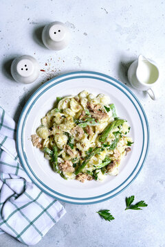 Pasta orecchiete with tuna and asparagus in a cream sause. Top view with copy space.
