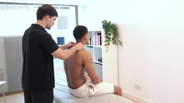 Physical therapist massaging a patient's shoulders and back