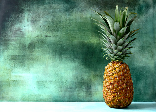 Different types of exotic fruits : pineapple, coconut, banana, orange, persimmon and pomegranate.
