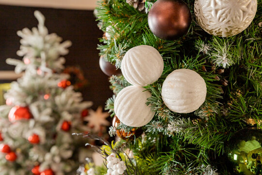 Decorating Christmas tree on bright background, White Christmas ball toy.Merry Christmas, Scandinavian style. Christmas decor. ornaments and garland lights, Christmas holidays background.