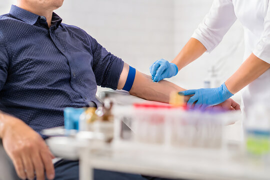 Preventive healthcare cholesterol screening with a patient and medical professional preparing a routine blood test in a bright clinic, candid side perspective with copy space.
