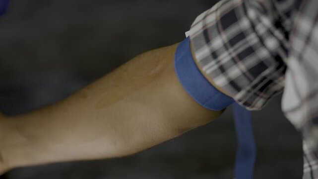 Healthcare Professional Collecting Blood Sample from Patient&rsquo;s Arm