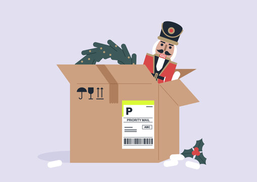A cardboard box full of Christmas decoration objects, a nutcracker, a wreath, a candy cane and holly berries