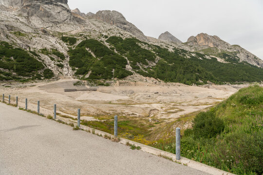Canazei, Italy. Lago di Fedaia reservoir with extensive exposed lakebed during drought and low water levels