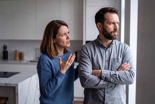 Unhappy couple fighting in kitchen, marriage crisis relationship problem