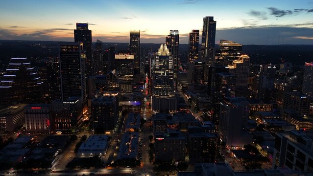Aerial view of downtown city lights of while the sun is setting