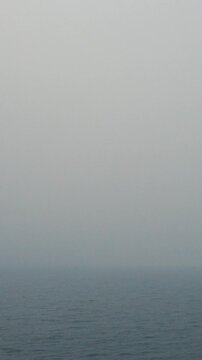 Sea surface with drifting fog and calm morning atmosphere