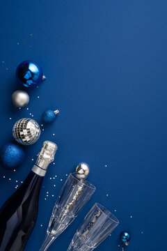 Happy New Year 2027 celebration with champagne, blue ornaments and elegant winter decor on vertical navy background