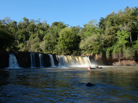 Scenic Rio Tembey River and Waterfall with Tourists in Paraguay