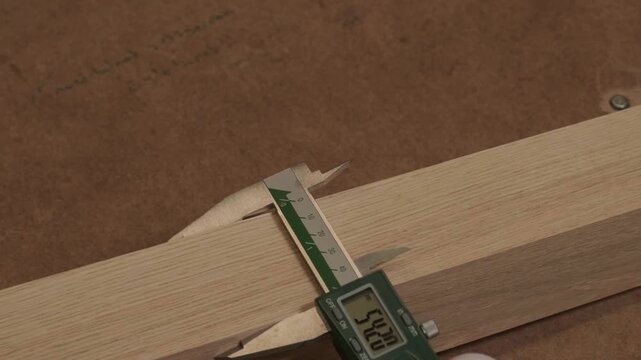 Close-up of industrial automated CNC woodworking machine cutting wood component in modern furniture factory