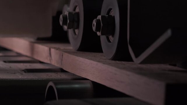 Close-up of industrial automated CNC woodworking machine cutting wood component in modern furniture factory