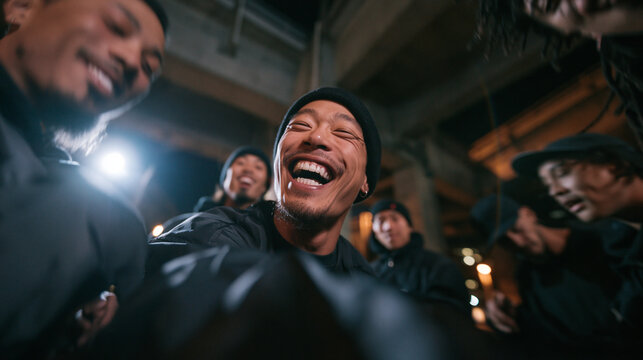 Group of Cheerful Young Friends Laughing Together at Night