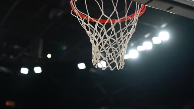  Close-up of basketball ball falling through the hoop net scoring a winning point