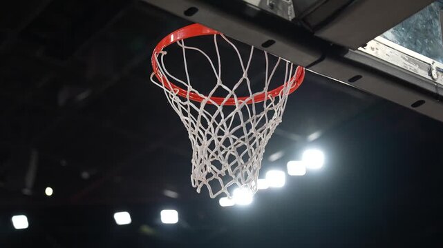  Close-up of basketball ball falling through the hoop net scoring a winning point