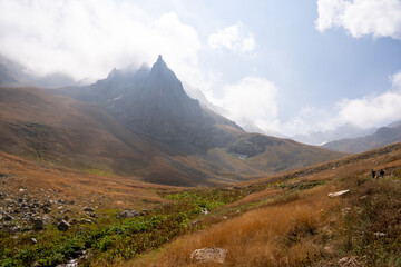 Naklejka premium Mountain landscape with clouds and meadows.