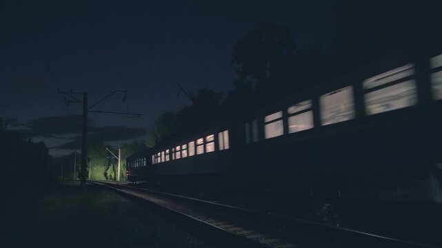 Wide-Angle Night Train Passing on Railway Track | Illuminated Passenger Carriage Windows Moving Through Dark Forest | Electric Railway Transportation at Night