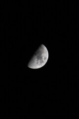 Moon in a waxing crescent or waning gibbous phase with a vertical black background © Alex Borderline