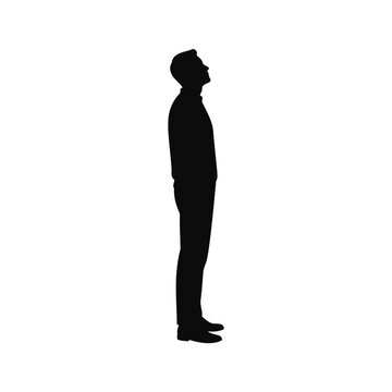 Silhouette of a man standing and looking up