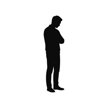 Silhouette of man standing with arms crossed