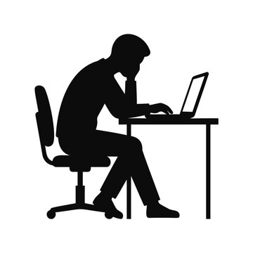 Silhouette of man working on laptop at desk