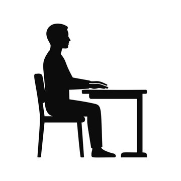 Silhouette of a man sitting at a desk