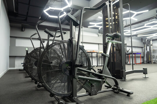 modern gym interior with equipment, fitness exercise bikes